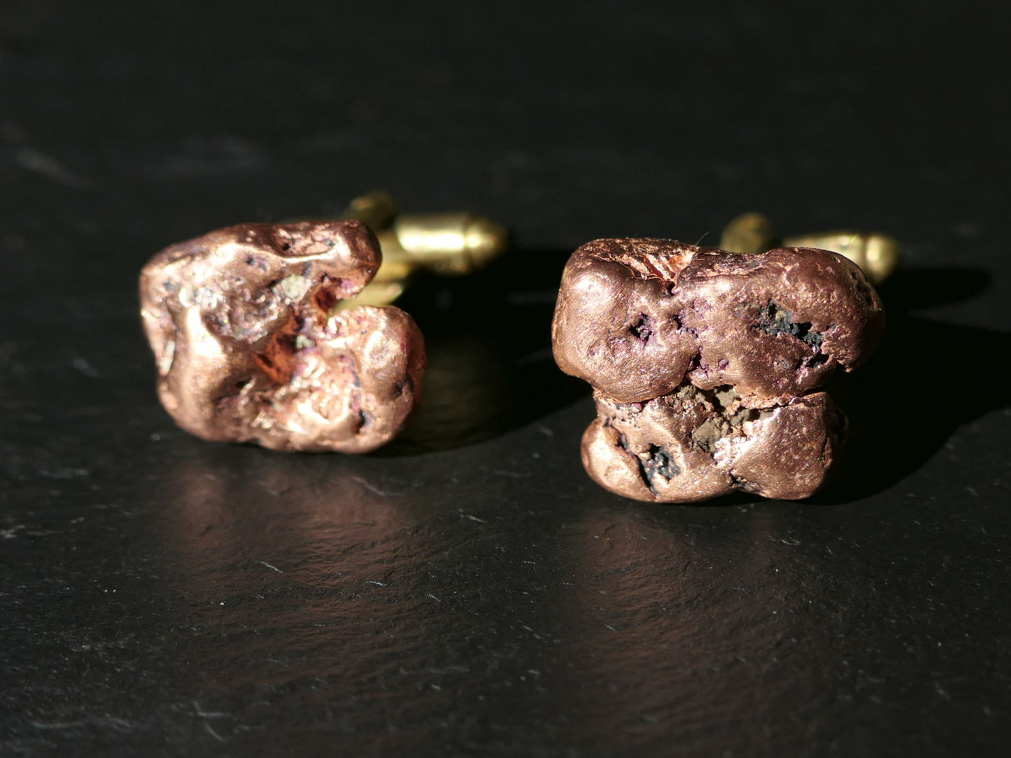 Michigan copper nugget cufflinks with natural copper nuggets and brass backs on dark surface