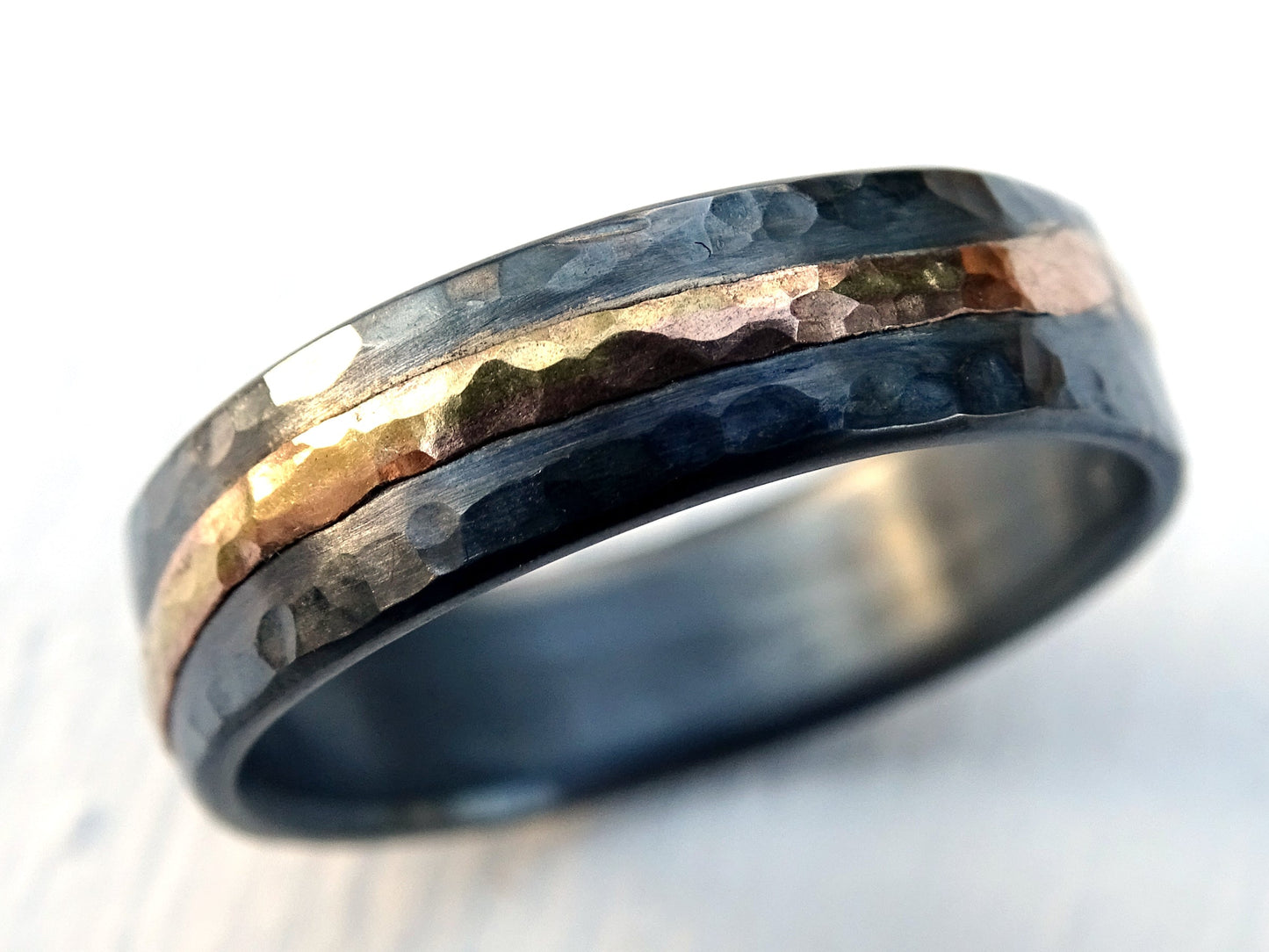handmade wedding ring with hammered sterling silver and 14k gold accent band with dark oxidized finish