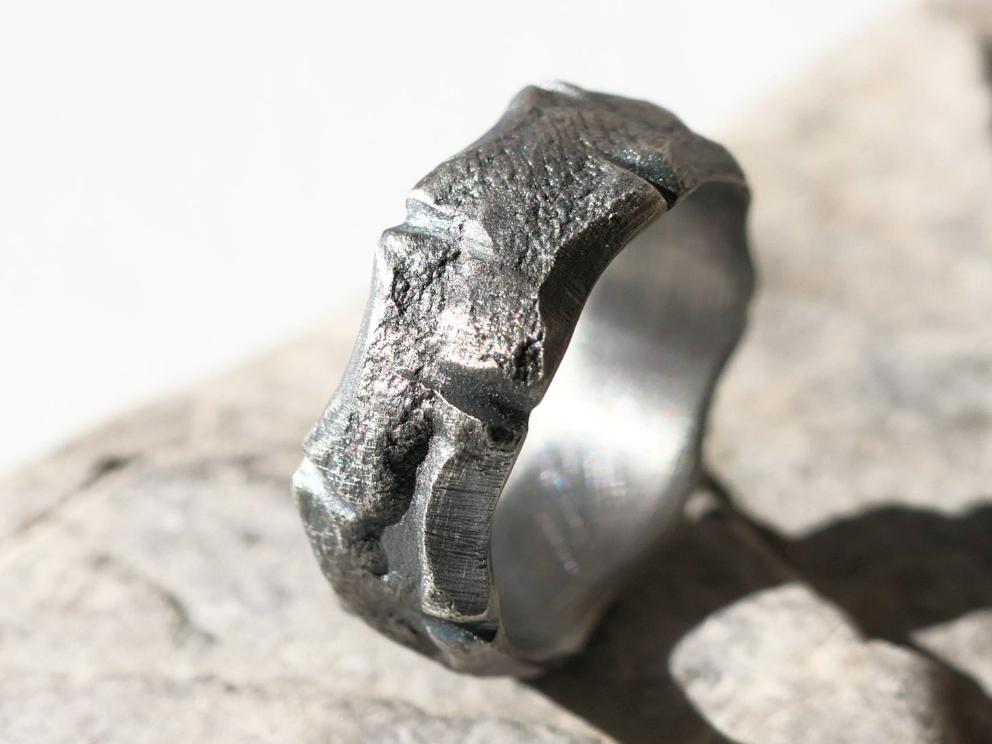 handmade men's silver wedding band with rustic molten texture and uneven edges crafted from sterling silver