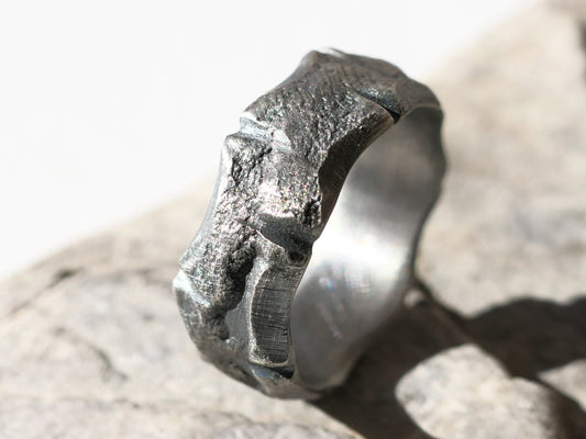 handmade men's silver wedding band with rustic molten texture and uneven edges crafted from sterling silver