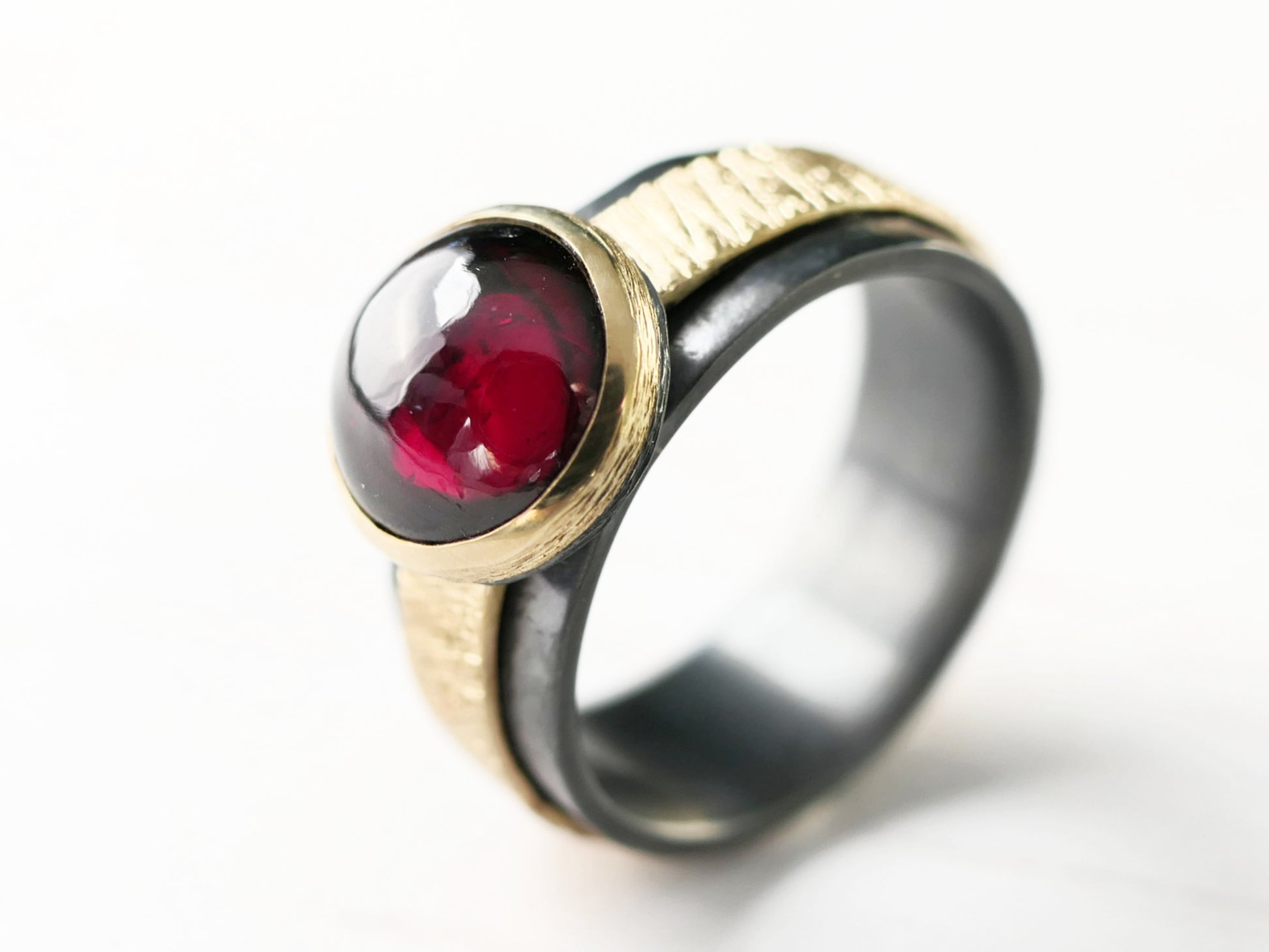 dark silver garnet ring with gold accents