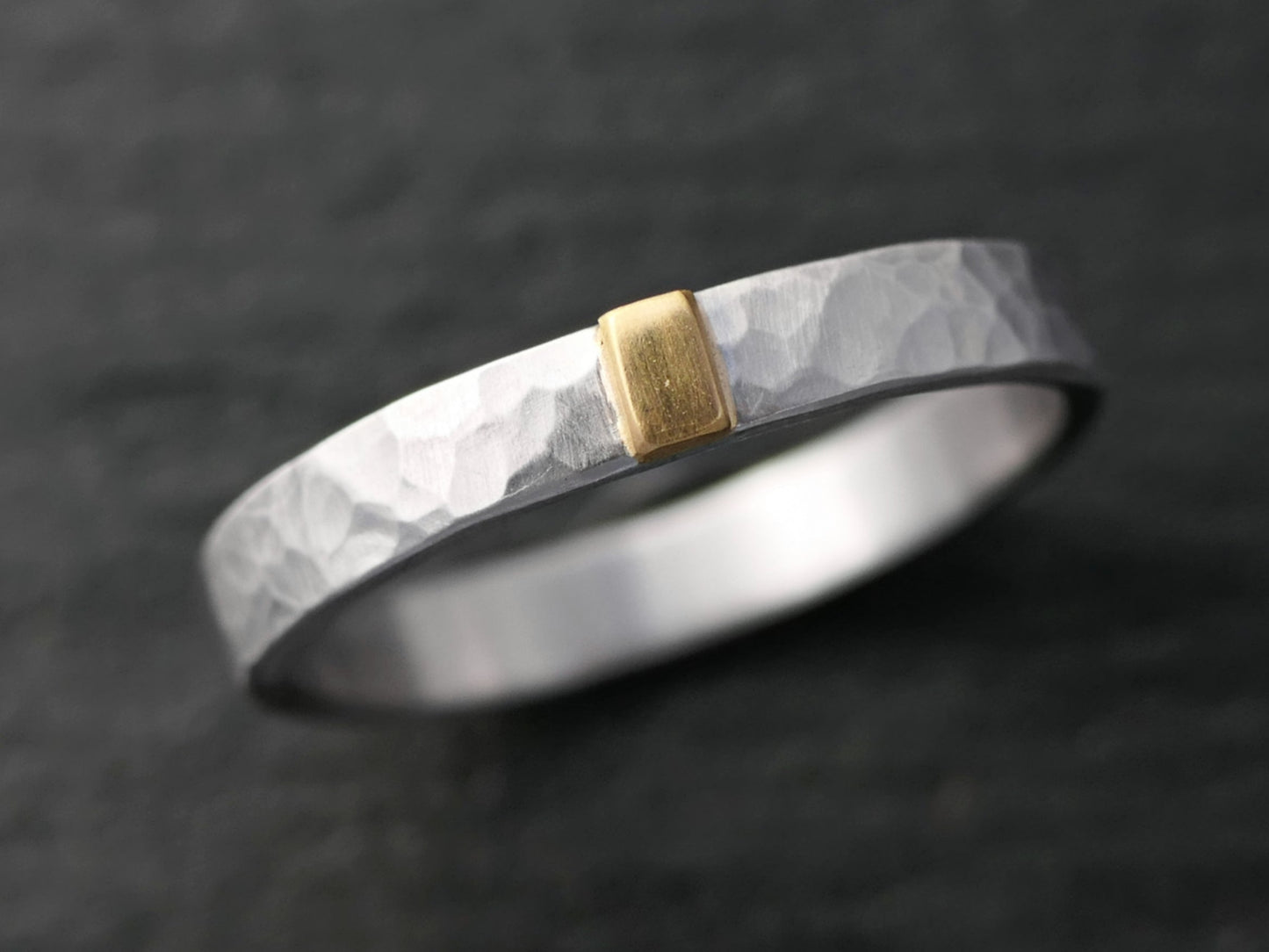 Hammered palladium ring with 22k gold accent and brushed matte finish on dark background