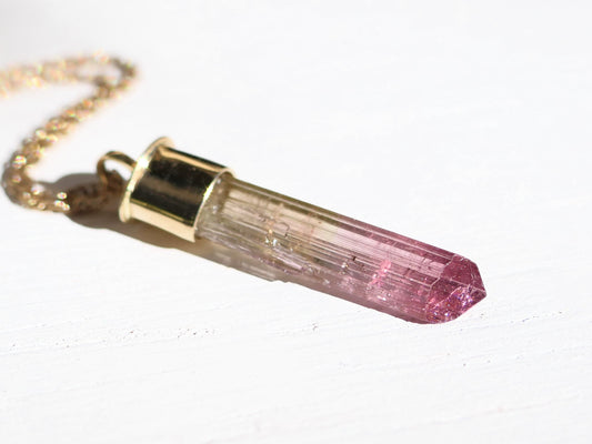 14k gold bi-color watermelon tourmaline crystal pendant with polished setting and gold chain