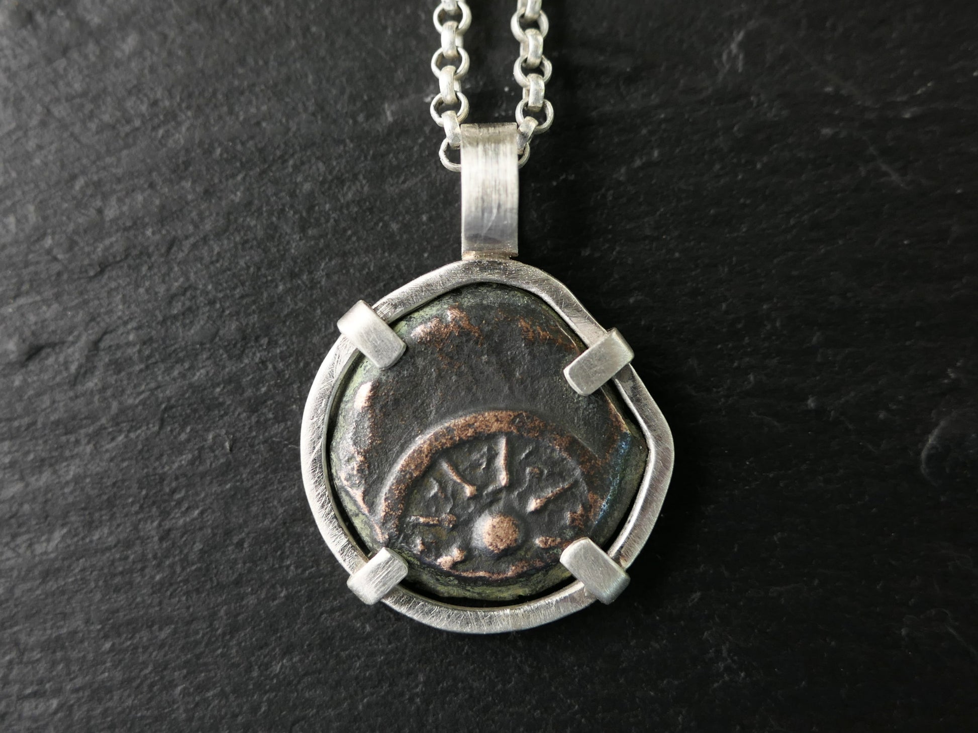 Sterling silver pendant featuring a genuine ancient widows mite bronze coin with 8-ray star design.