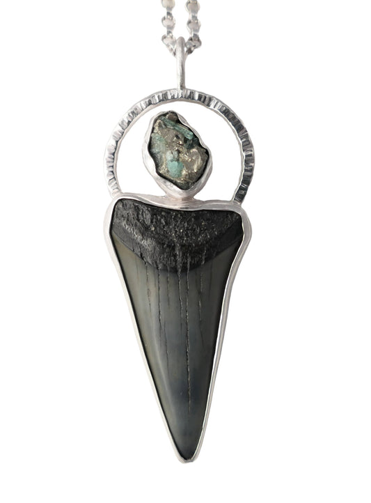Fossilized Hastalis shark tooth pendant set in sterling silver with raw emerald and pyrite crystal accent on a sterling silver chain
