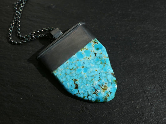 Large blue turquoise pendant in black oxidized silver setting with sterling silver chain.