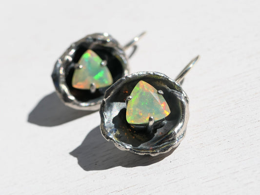 Organic welo opal earrings in sterling silver, featuring rainbow gemstones in dangle design.