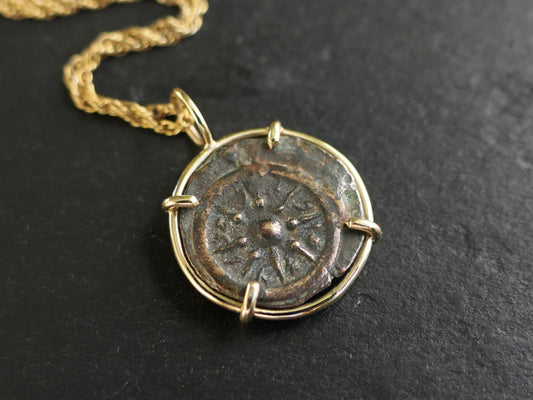 Ancient widows mite bronze coin pendant set in 14k gold with chain, detailed craftsmanship.