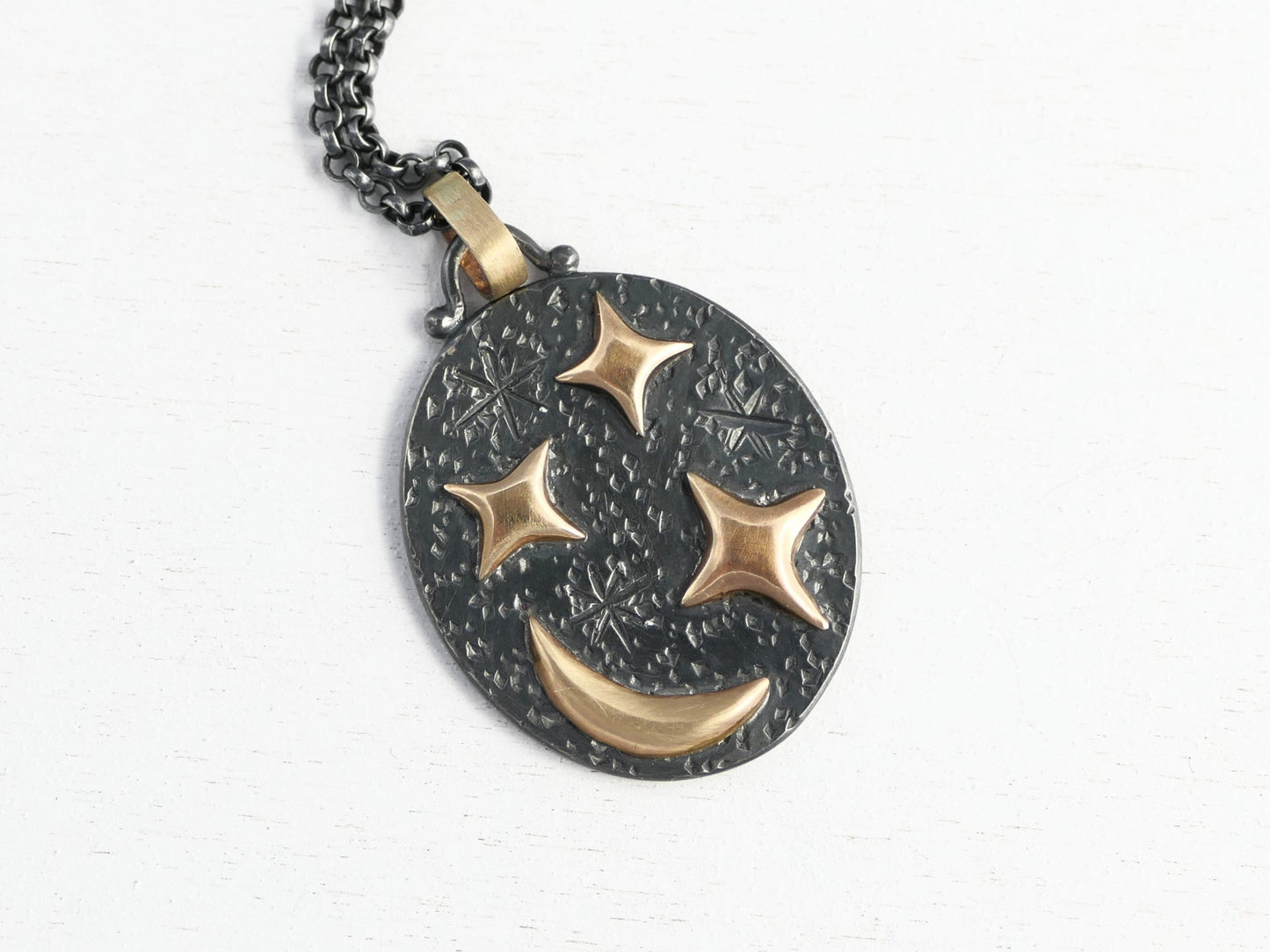 Black silver oval pendant with 14k gold crescent moon and stars on black sterling silver chain