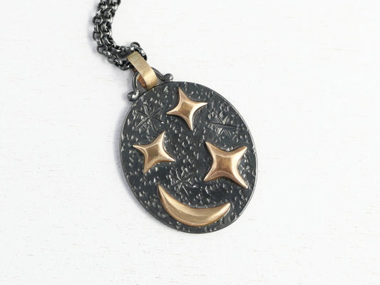 Black silver oval pendant with 14k gold crescent moon and stars on black sterling silver chain