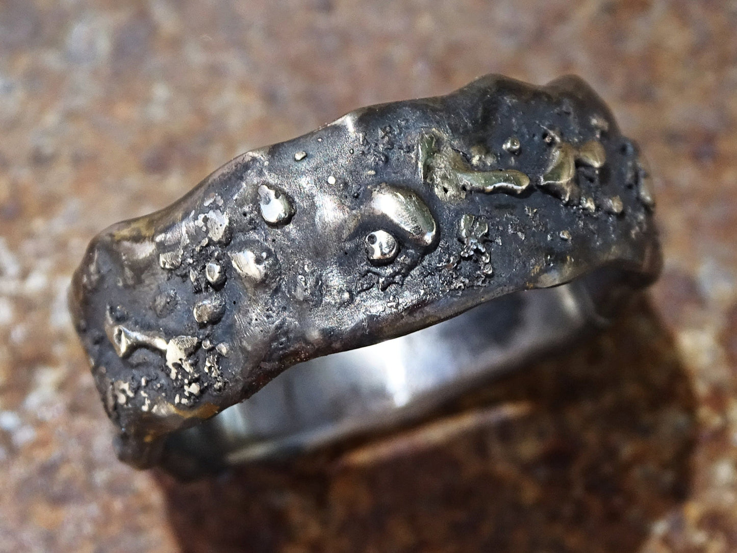 black white gold men's wedding band ring with unique molten texture handcrafted from recycled 14k white gold