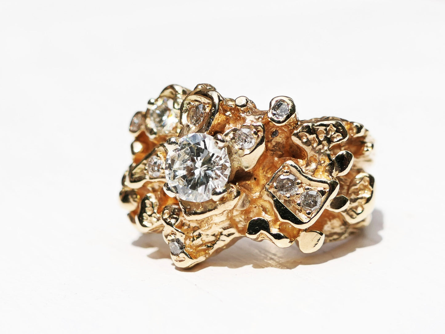 14k gold diamond statement ring with nine salt and pepper diamonds in unique settings