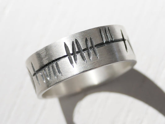 Handmade sterling silver Ogham ring with rustic engraved Ogham script on a 7mm wide band