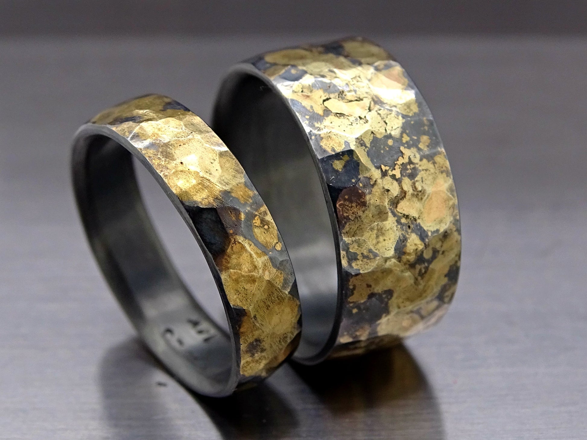 hammered ring set with dark silver and gold bands featuring unique hammered texture
