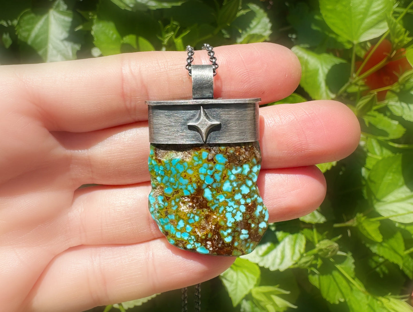 dark silver turquoise pendant on a black chain