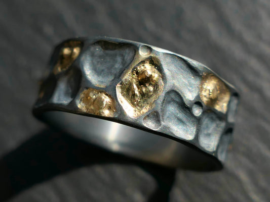 Hand carved sterling silver wedding ring with irregular 14k gold inlays, featuring organic cell texture and unique handmade design.