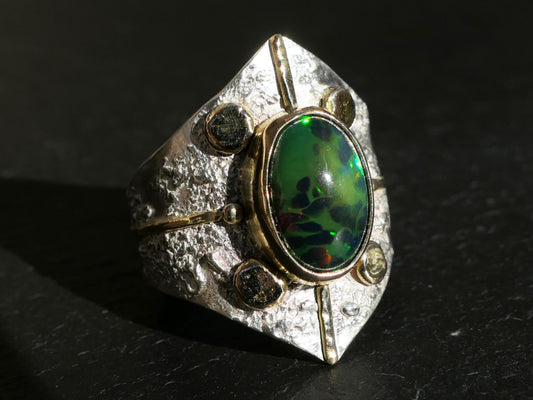 Large statement ring with black welo opal gemstone set in sterling silver and 14k gold accents