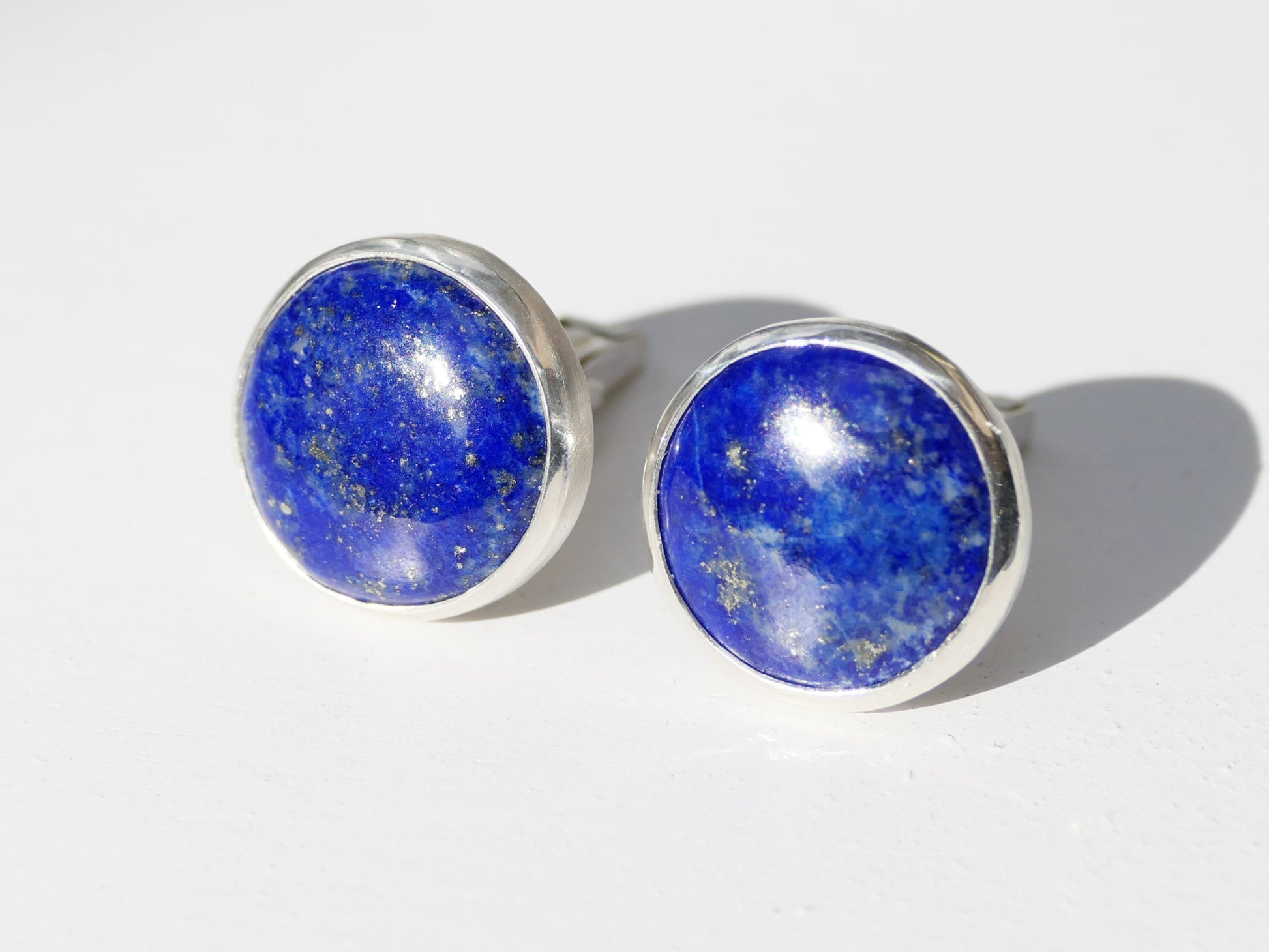 Handmade blue lapis lazuli cufflinks in sterling silver with pyrite specks, 15.5mm cabochons.