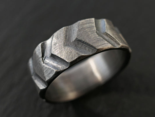 Sterling silver tire ring with carved chevron tread pattern in dark oxidized finish