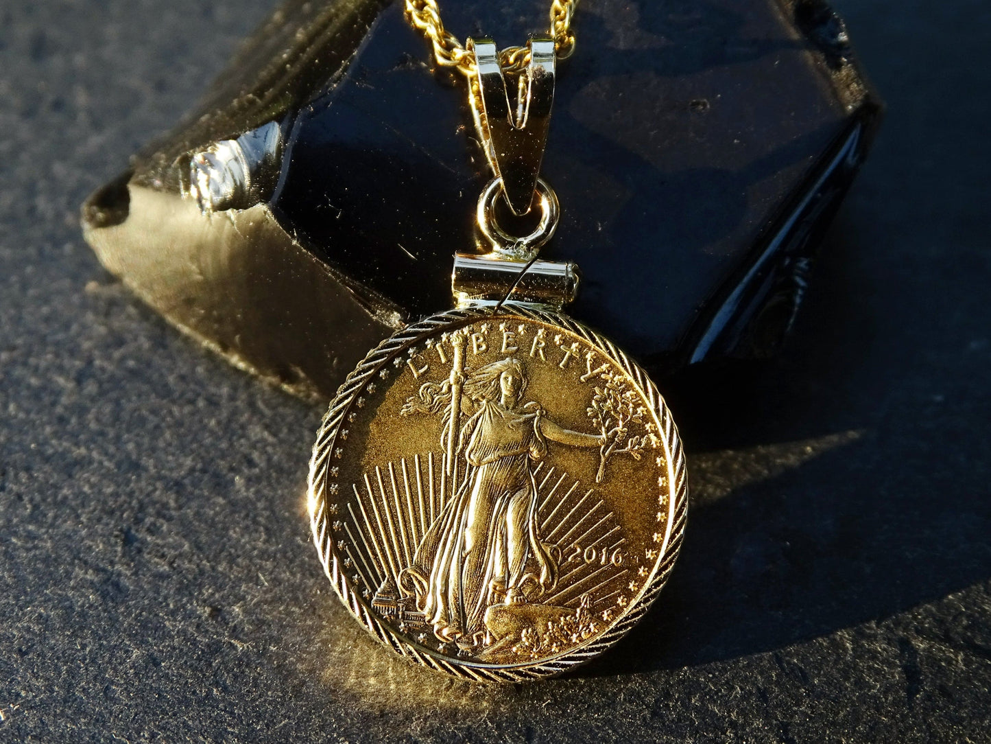 14k yellow gold pendant featuring an authentic 2016 American Gold Eagle coin with a detailed Liberty design and gold plated chain
