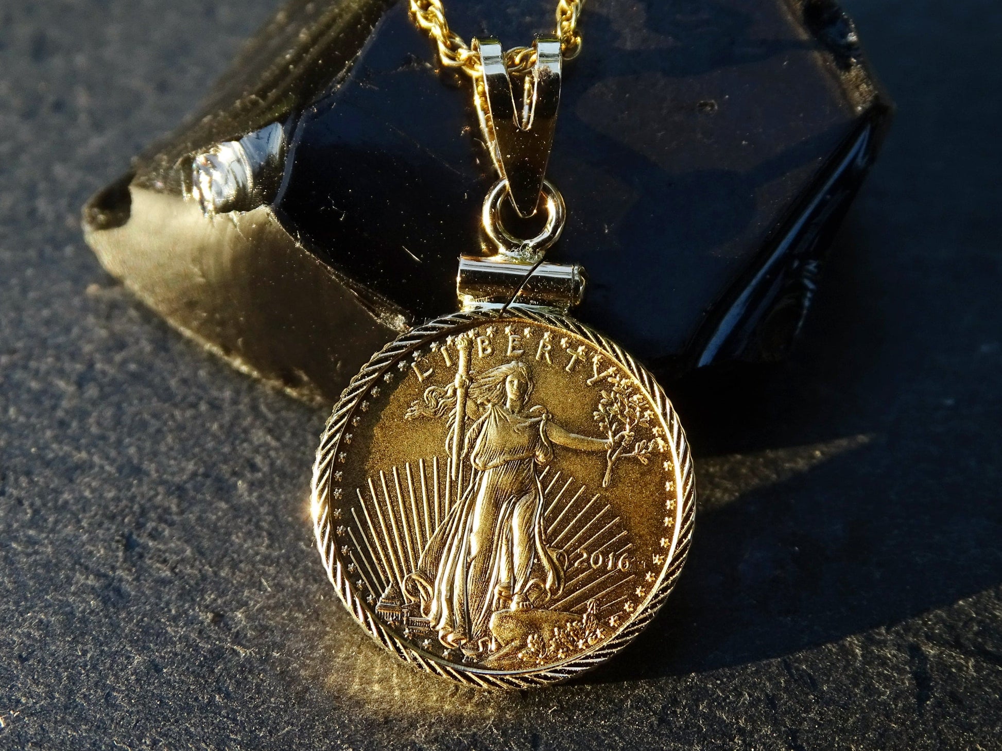 14k yellow gold pendant featuring an authentic 2016 American Gold Eagle coin with a detailed Liberty design and gold plated chain