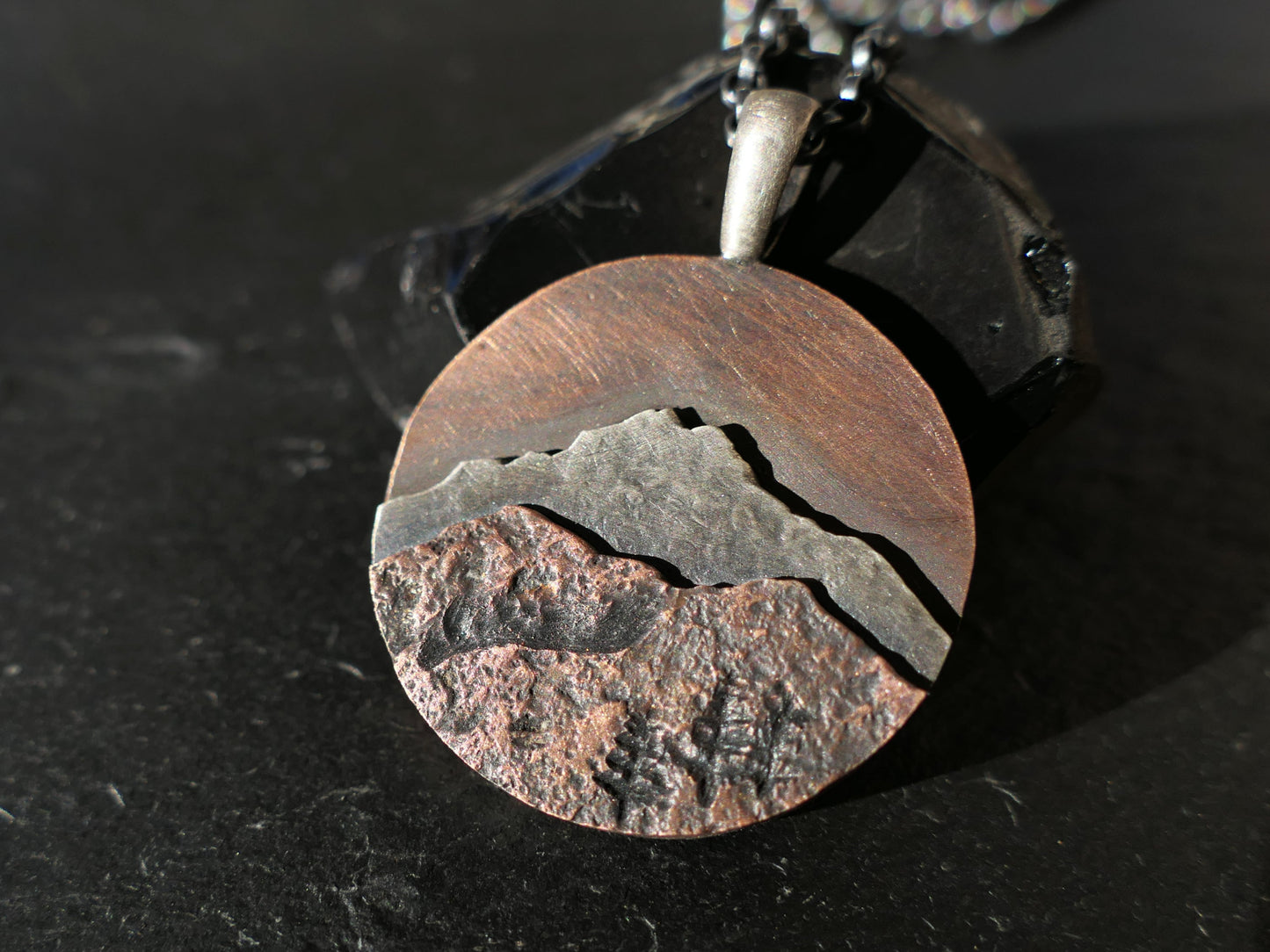 rustic mixed metal mountain range pendant necklace with sterling silver and copper layers on black chain