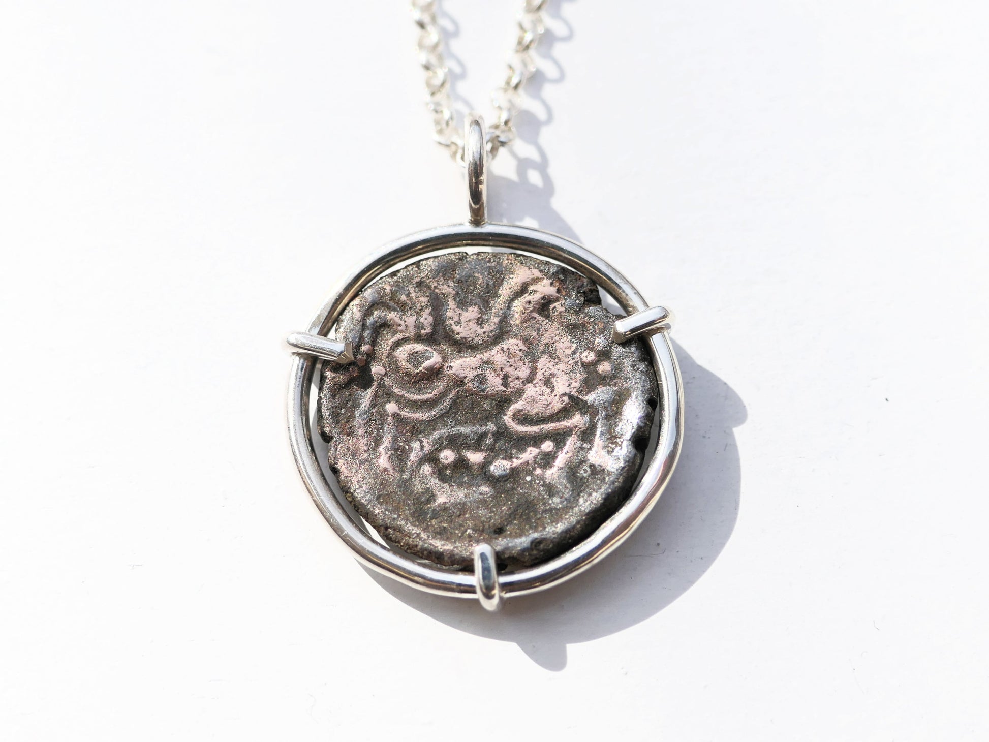 Celtic coin necklace with bronze horse coin pendant in sterling silver setting.
