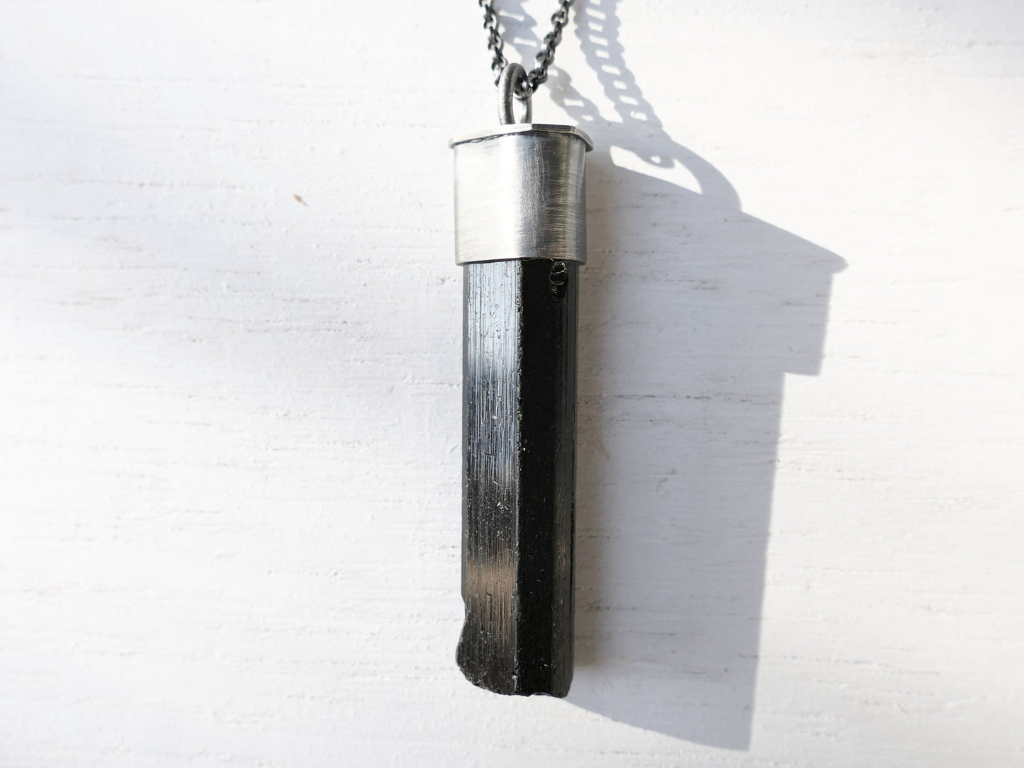 large black tourmaline crystal pendant in dark oxidized sterling silver setting with black silver chain