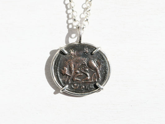 ancient Urbs Roma coin necklace with sterling silver setting and chain featuring authentic Roman Empire she-wolf coin.