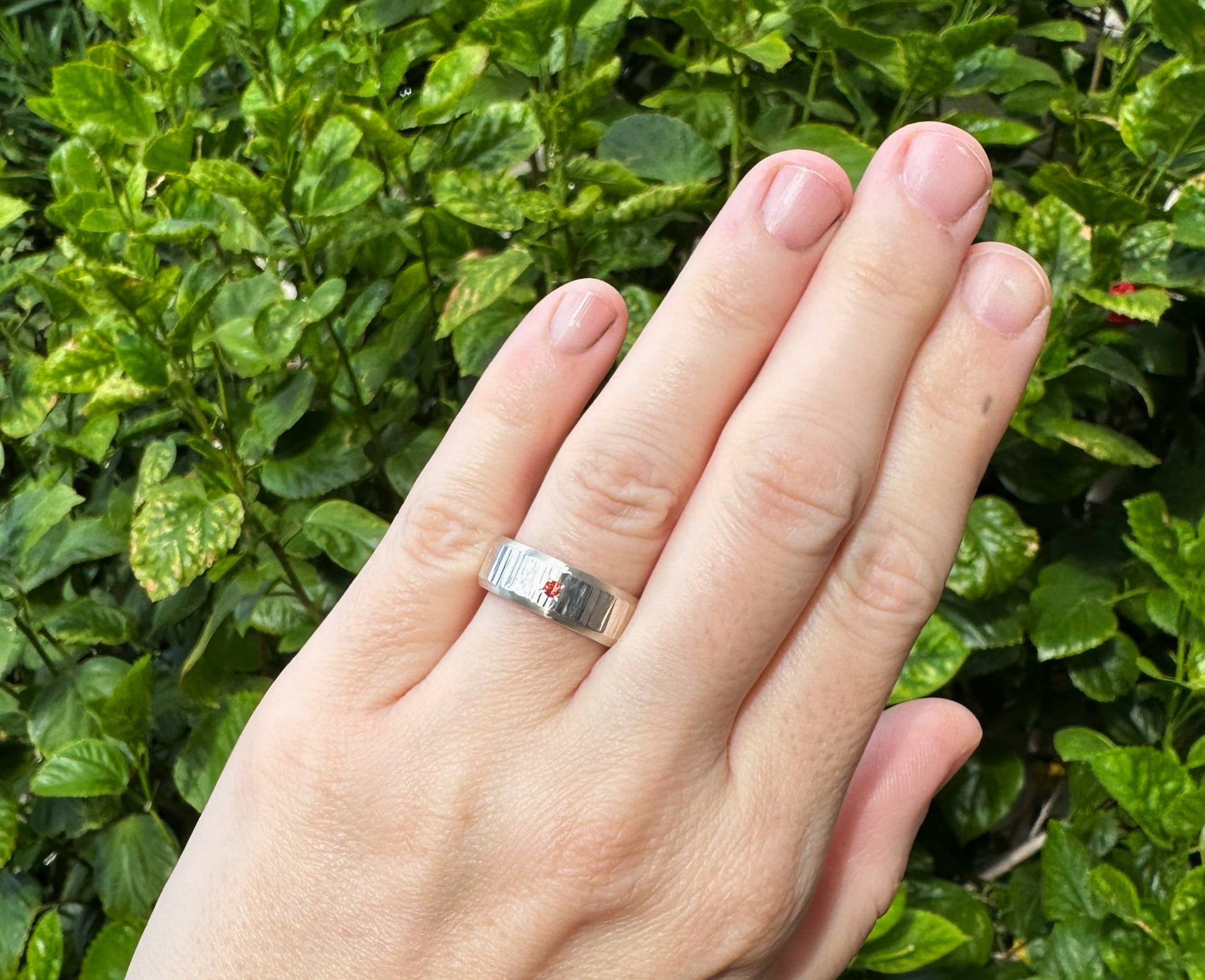 textured silver wedding band with flush set gemstone