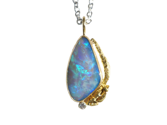 Statement Australian opal pendant with gold nugget and diamond, featuring vibrant blue-green opal, solid 18k yellow gold, and small diamond accent.