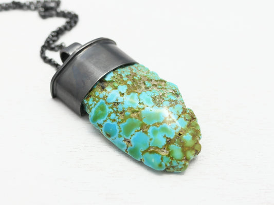 Dark silver Arizona turquoise pendant with large turquoise nugget in oxidized silver setting.