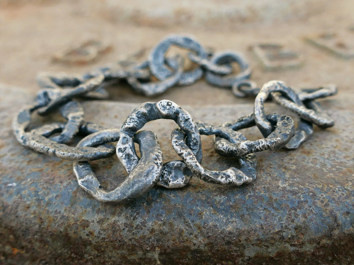 heavy sterling silver chain bracelet with dark oxidized large solid links and molten texture