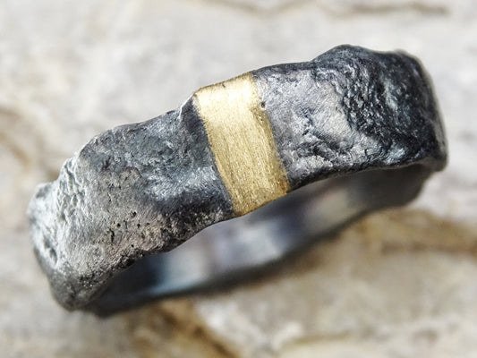 modern mens wedding band with molten oxidized silver texture and 14k gold inlay center strip