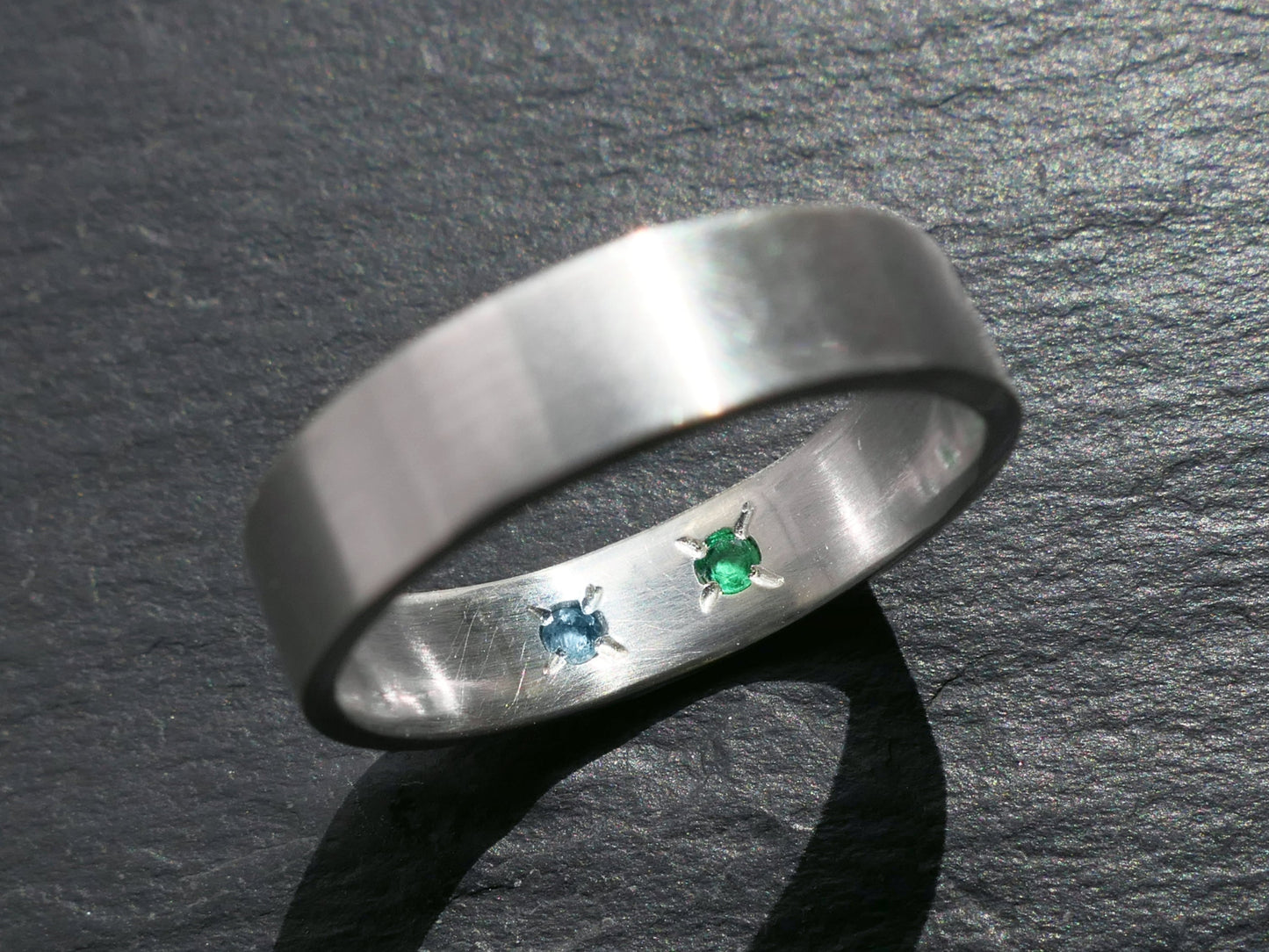 Sterling silver ring with hidden gemstones on inner band.