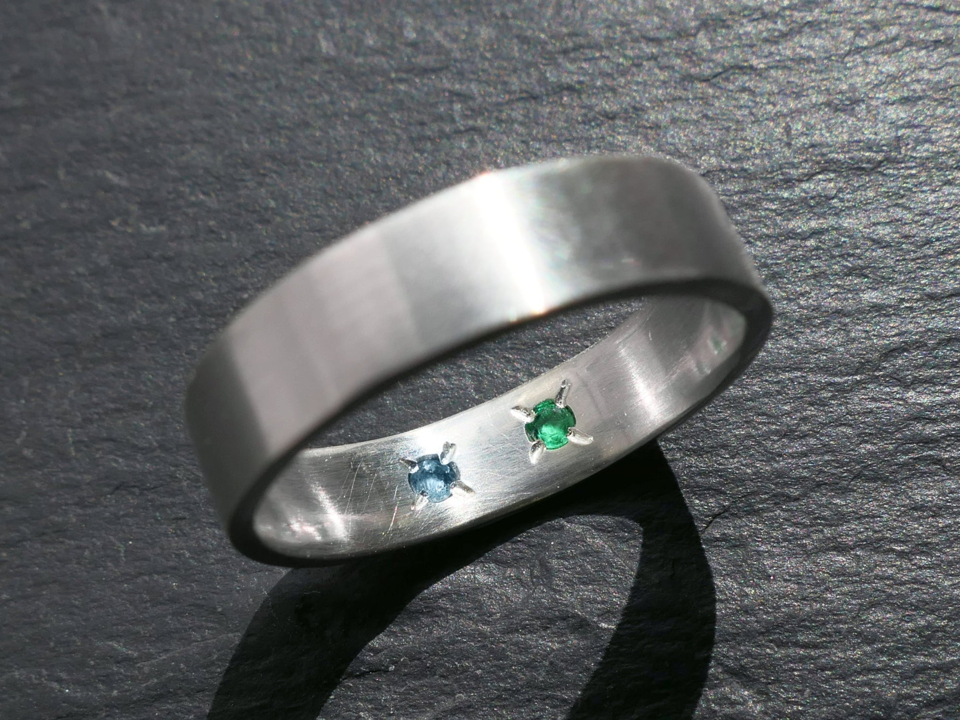 Sterling silver ring with hidden gemstones on inner band.