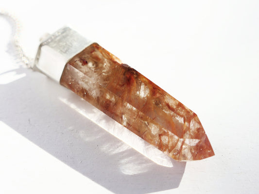 Red amphibole quartz pendant in handcrafted sterling silver setting.