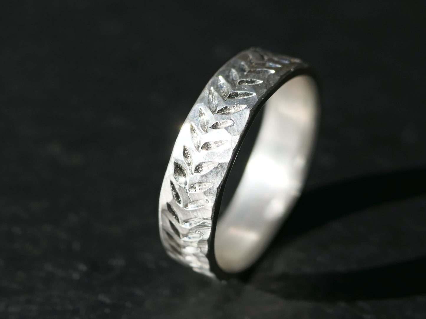 hand engraved rustic organic silver wedding band with hammered texture and uneven edges