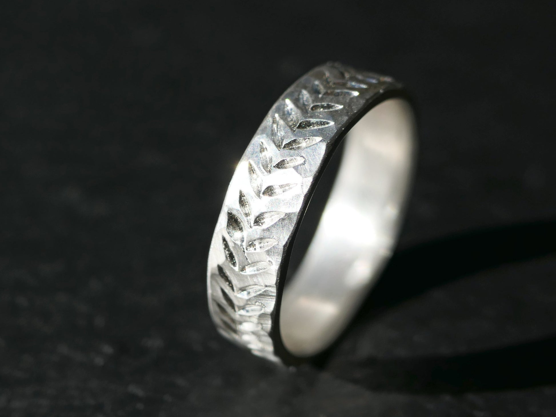 hand engraved rustic organic silver wedding band with hammered texture and uneven edges