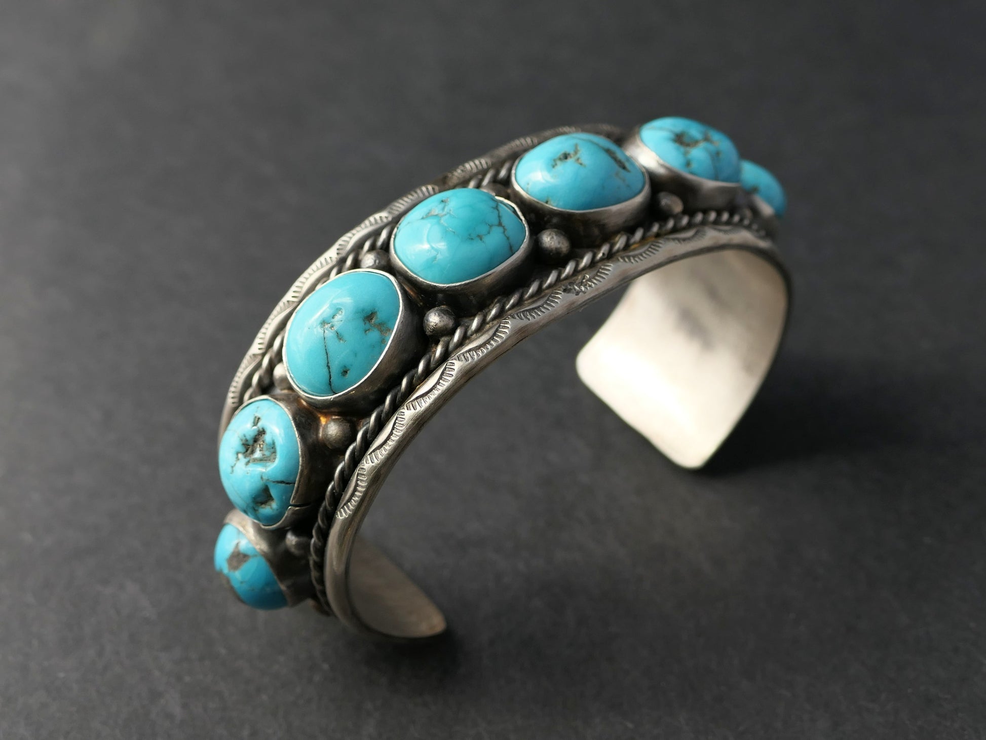 Large Navajo sterling silver cuff bracelet with eight genuine Kingman turquoise stones and traditional stamped design