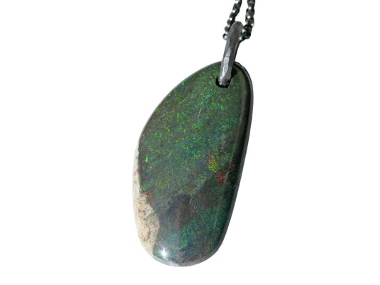 Large Andamooka opal pendant with black sterling silver chain, showcasing a dark polished Australian opal with green and red pinfire colors.