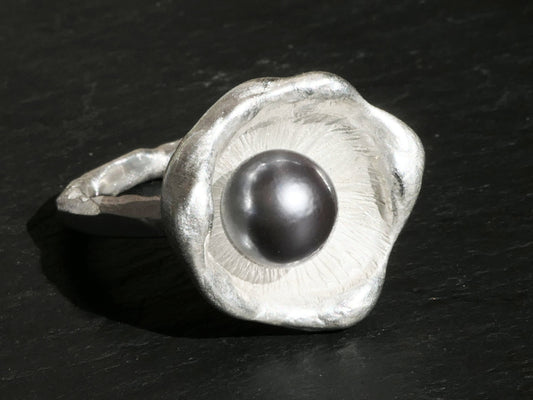 Sterling silver ring with a round grey Tahiti pearl set in a unique watercast dish design