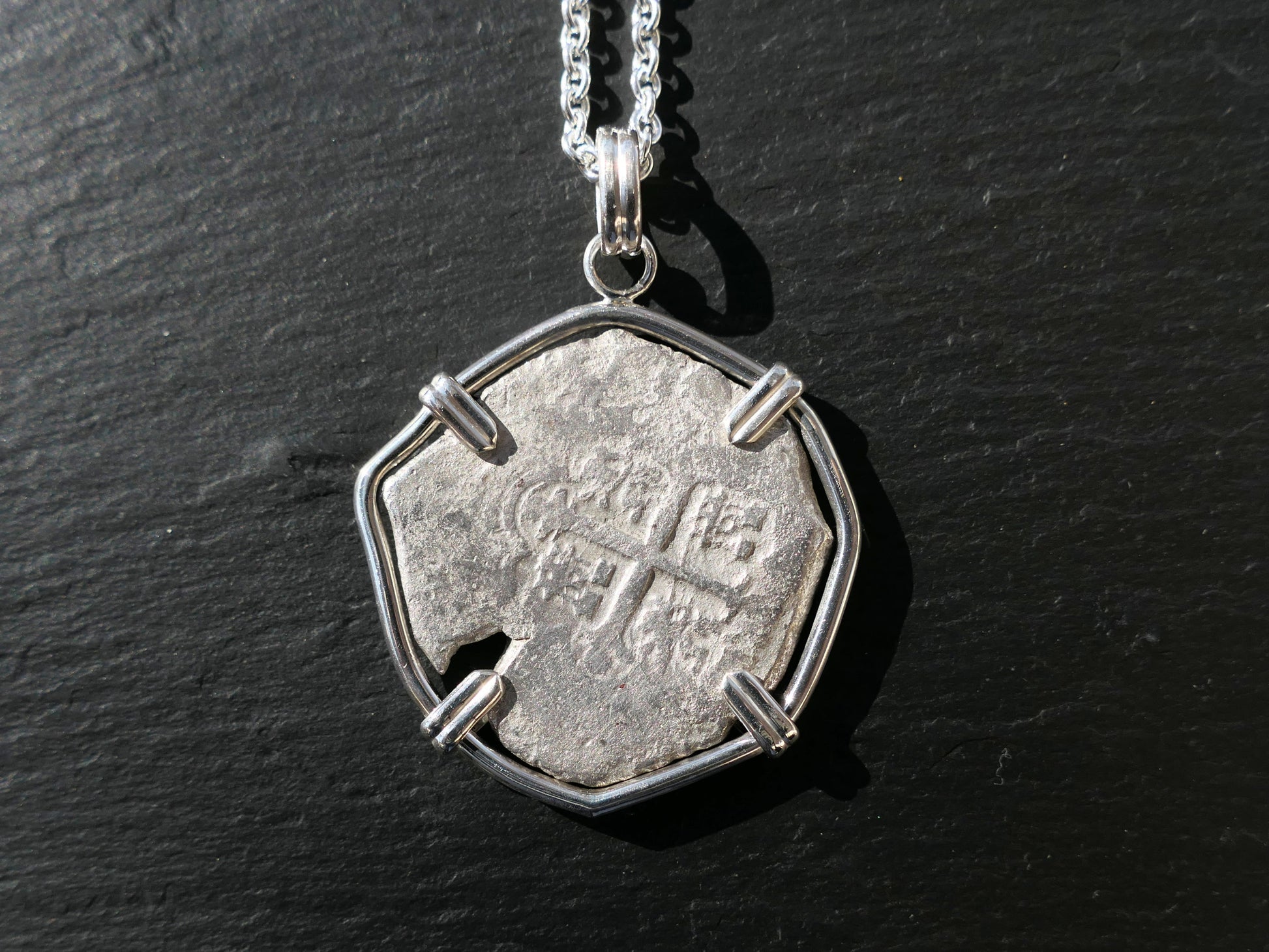 Spanish colonial silver treasure coin necklace with authentic coin from 1572-1734, in sterling silver setting.
