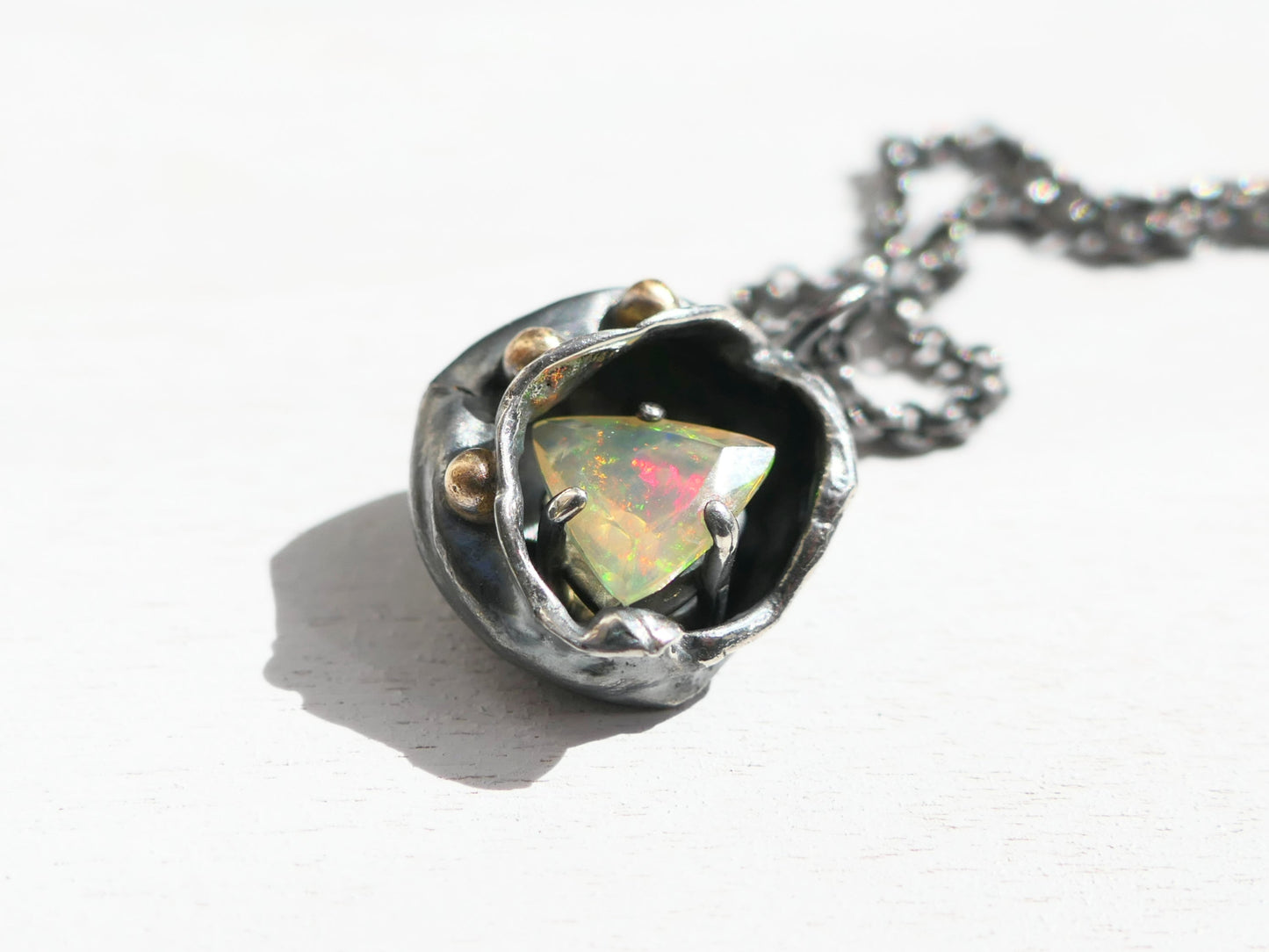 watercast welo opal pendant in dark silver and 14k gold with rainbow play of color