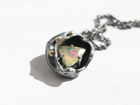 watercast welo opal pendant in dark silver and 14k gold with rainbow play of color
