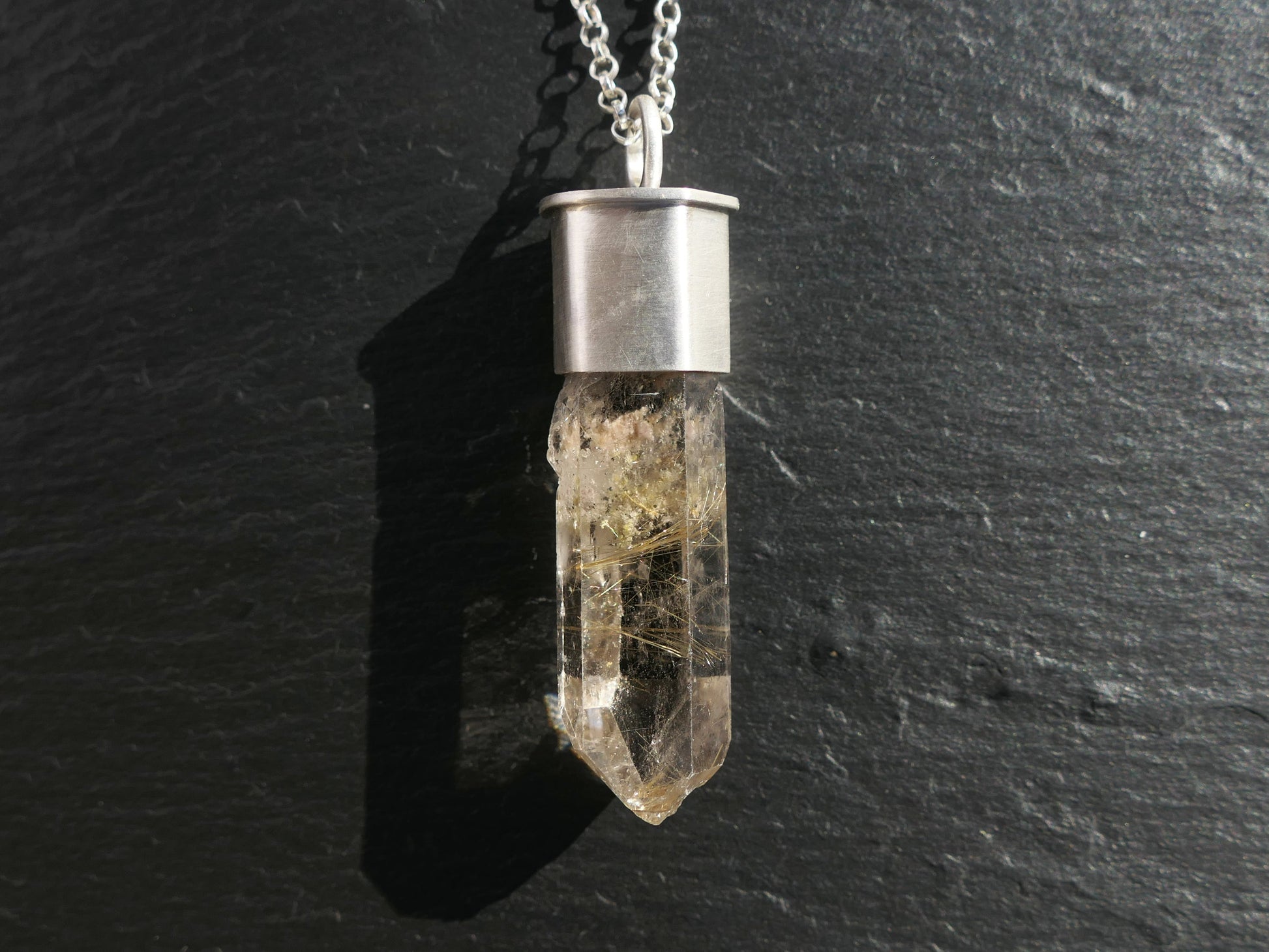 Golden Rutile in Smoky Quartz crystal necklace with sterling silver setting.