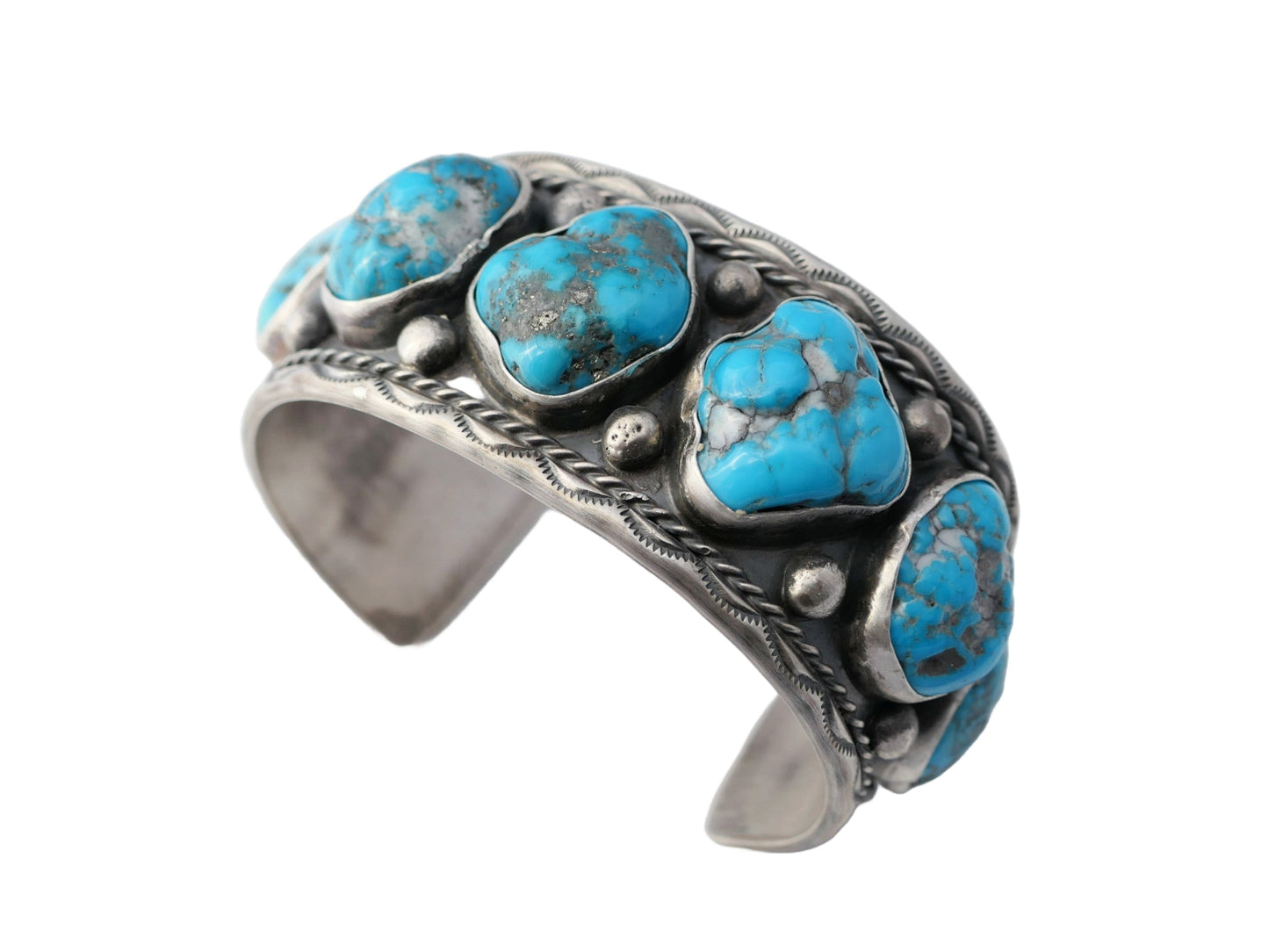 large turquoise cuff bracelet with seven Kingman turquoise stones set in sterling silver with Navajo design details