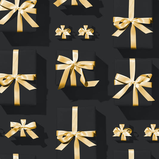Black gift boxes with gold ribbons symbolizing CrazyAss Jewelry Designs gift card present options