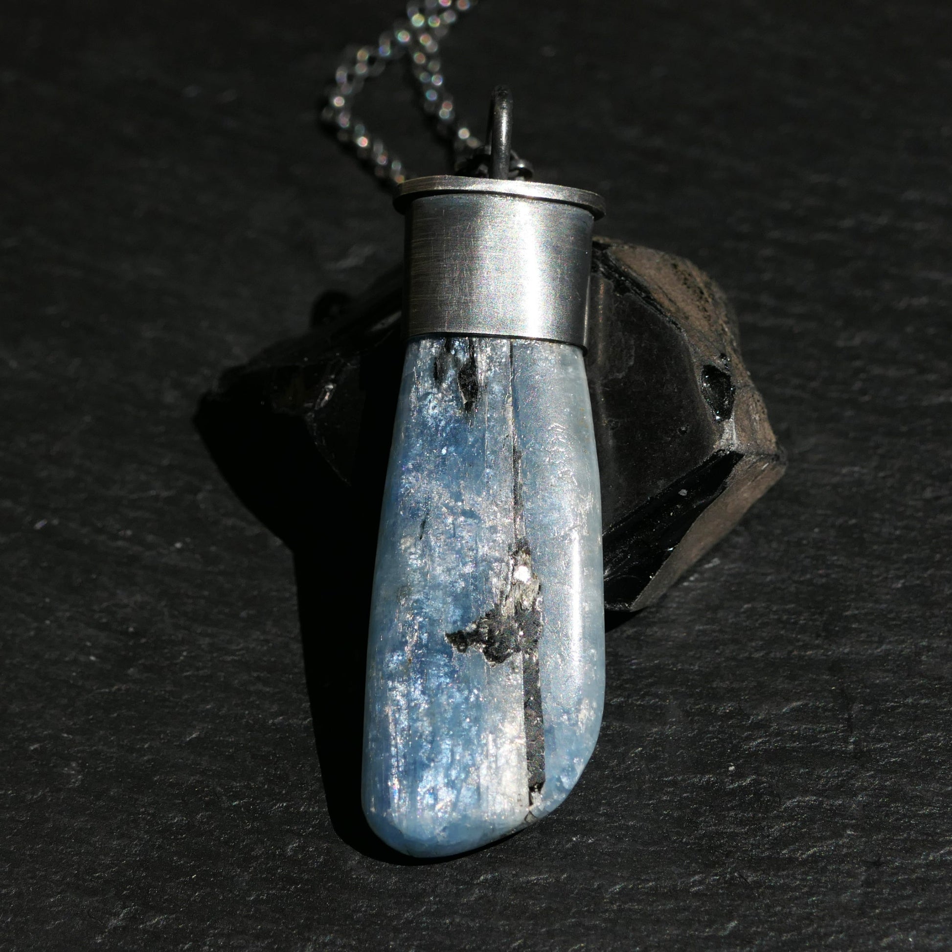 dark sterling silver kyanite pendant with natural blue chatoyant gemstone on chain