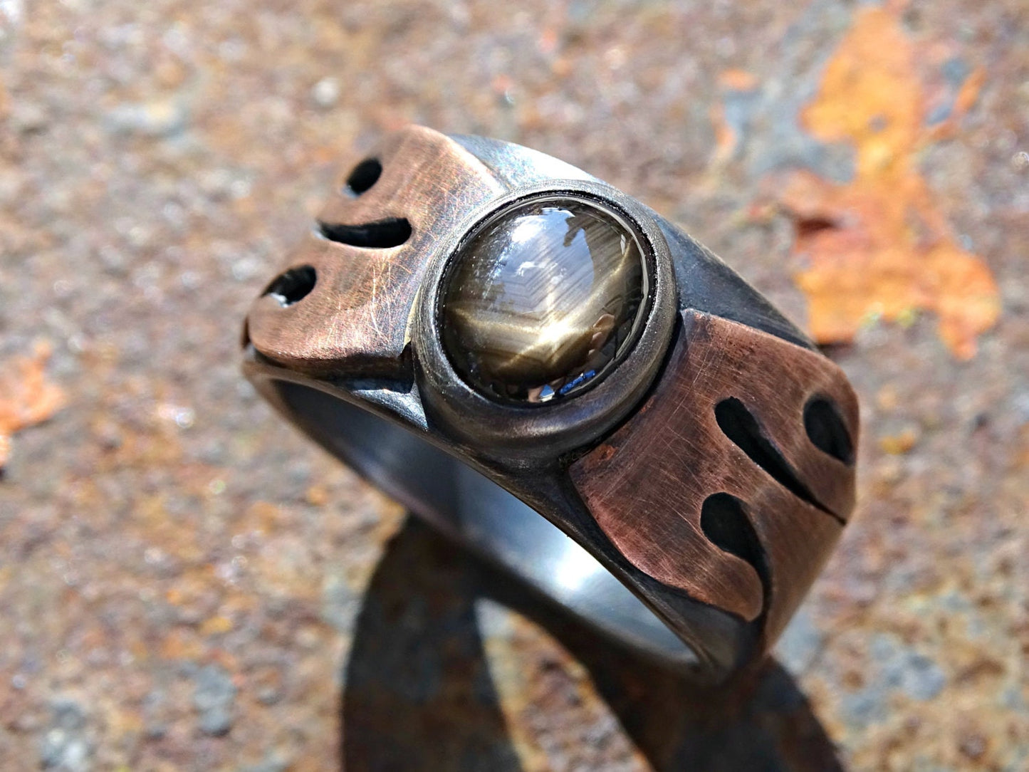 Mens statement ring with black star sapphire and copper flame design handcrafted from oxidized sterling silver